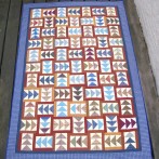 Ginny’s Plaid Flying Geese Quilt