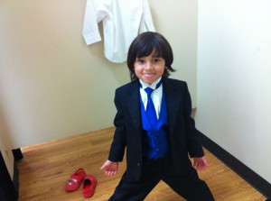 Here is Remi, maybe the cutest ring bearer ever. His mom said "I said make a happy face, and he said "I'm a spy prince and I have to keep the rings safe because they make Katy be married" then he made this face"