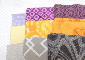 Light, Medium and Dark fabrics in yellow/gold, gray and purple