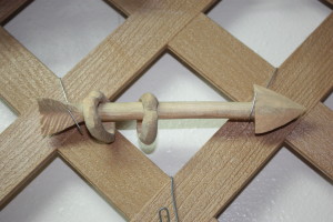 carved wooden arrow with hearts
