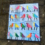 Baby quilt with bird blocks