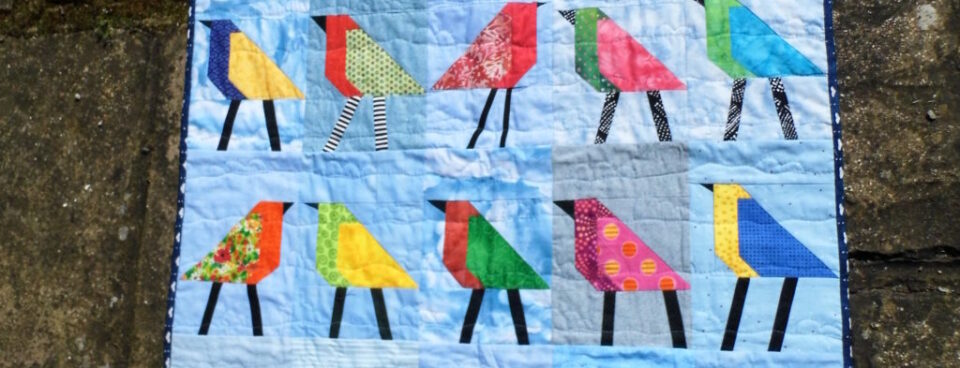 Baby quilt with bird blocks